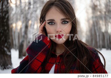 Woman with red lips in winter forest Woman with red lips in winter forest 84985177