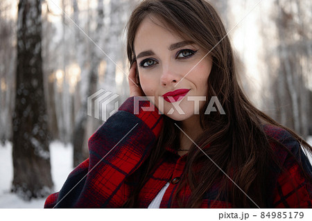 Woman with red lips in winter forest Woman with red lips in winter forest 84985179