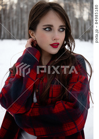 Woman with red lips in winter forest Woman with red lips in winter forest 84985180