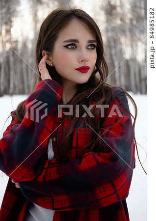 Woman with red lips in winter forest Woman with red lips in winter forest 84985182