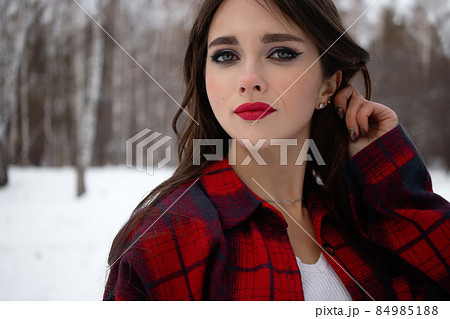 Woman with red lips in winter forest Woman with red lips in winter forest 84985188