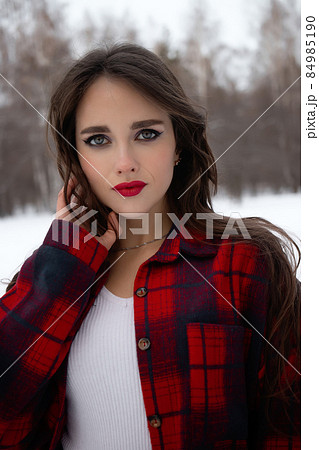 Woman with red lips in winter forest Woman with red lips in winter forest 84985190