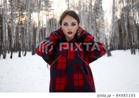 Woman with red lips in winter forest 84985193