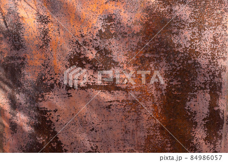 Rusty metal background. Red metal texture with rust. Rust stains a lot and Sun rays, noisy background. Rusty metal background. Red metal texture with rust. Rust stains a lot and Sun rays, noisy background. 84986057