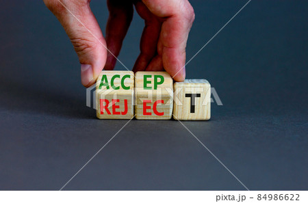 Accept or reject symbol. Businessman turns wooden cubes and changes the word reject to accept. Beautiful grey table, grey background, copy space. Business and accept or reject concept. 84986622