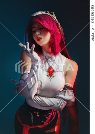 Studio portrait. Gothic anime character rosary sexy killer woman with pink hair in red and white. In a sexy pose on a dark blue dark background 84986698