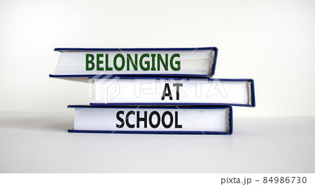 Belonging at school symbol. Books with words 'Belonging at school' on beautiful white background. Business, belonging at school concept. Copy space. Belonging at school symbol. Books with words 'Belonging at school' on beautiful white background. Business, belonging at school concept. Copy space. 84986730