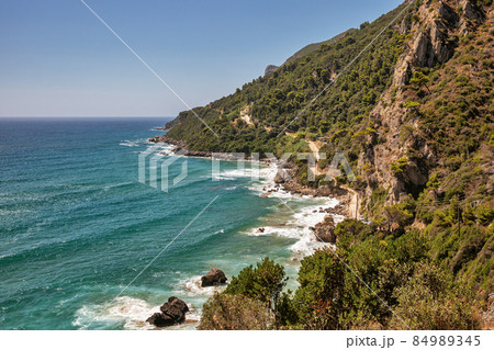 Sea waves crashing onto rocks with water splashes. Corfu island, Greece. Sea waves crashing onto rocks with water splashes. Corfu island, Greece. 84989345
