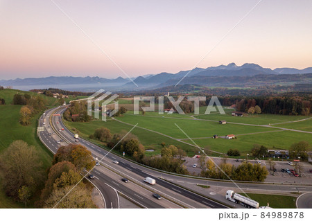 Top down aerial view of freeway interstate road with moving traffic cars in rural area. 84989878