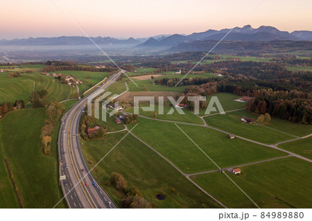 Top down aerial view of freeway interstate road with moving traffic cars in rural area. Top down aerial view of freeway interstate road with moving traffic cars in rural area. 84989880