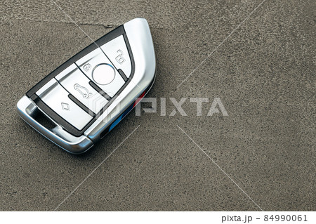 Modern automobile car key on black concrete background 84990061