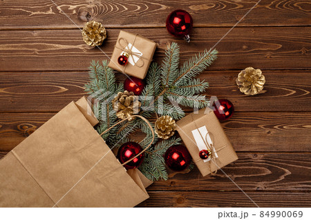 Spruce branches and red Christmas baubles top view Spruce branches and red Christmas baubles top view 84990069