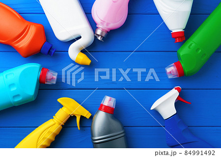 Household cleaning supplies on blue wooden background flat lay Household cleaning supplies on blue wooden background flat lay 84991492