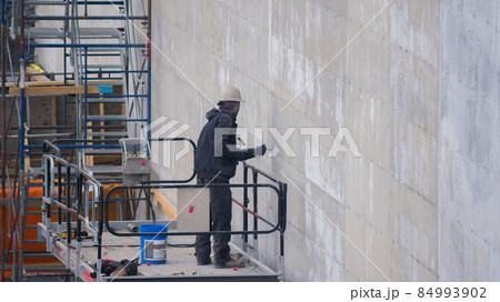 construction site scaffolding man at work lift hammer nail concrete wall building construction site scaffolding man at work lift hammer nail concrete wall building 84993902