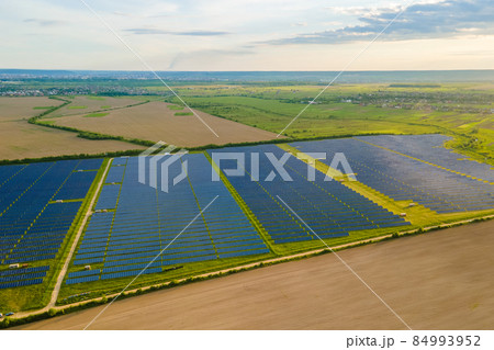 Aerial view of large sustainable electrical power plant with many rows of solar photovoltaic panels for producing clean ecological electric energy. Renewable electricity with zero emission concept. 84993952