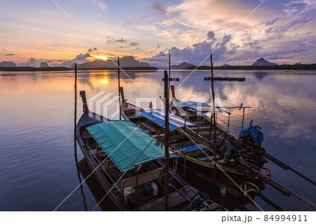 Ban Sam Chong Tai and colorful sunrises that emerges behind the giant limestone mountains, Thailand Ban Sam Chong Tai and colorful sunrises that emerges behind the giant limestone mountains, Thailand 84994911