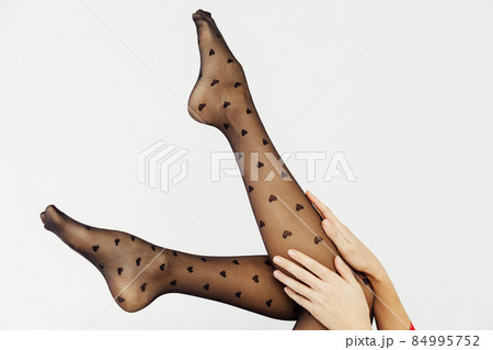 beautiful slender women's legs in black tights stockings 84995752