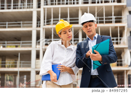 Man and woman engineers planning project of new building 84997295