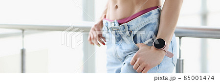 Beautiful pumped up press of young woman in jeans closeup 85001474