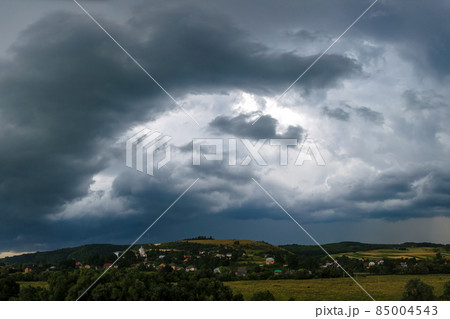 Landscape of dark clouds forming on stormy sky during thunderstorm over rural area. Landscape of dark clouds forming on stormy sky during thunderstorm over rural area. 85004543