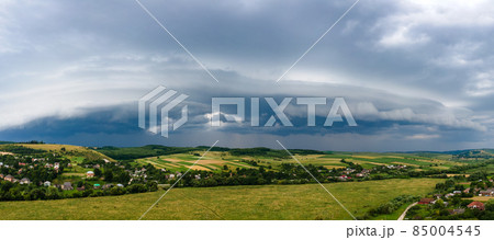 Landscape of dark clouds forming on stormy sky during thunderstorm over rural area. Landscape of dark clouds forming on stormy sky during thunderstorm over rural area. 85004545
