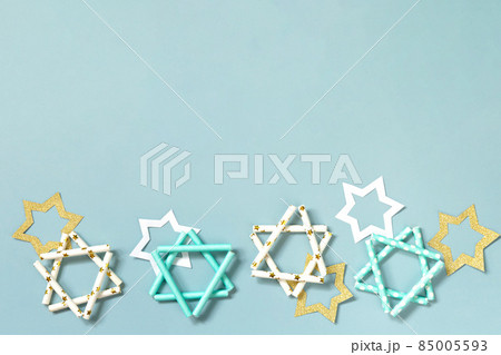 Jewish holiday Hanukkah. Symbol of Hanukkah star of David on a blue background. Top view flat lay. Copy space. 85005593