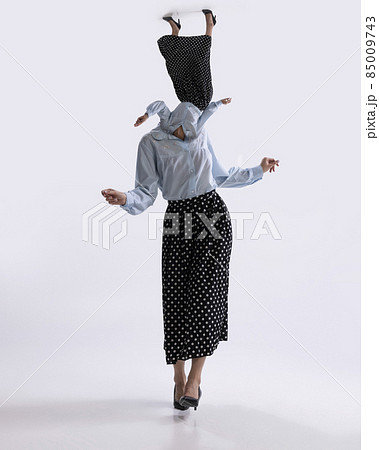 Surreal artwork with portrait of young dancing woman dressed in 50s, 60s style with own body instead head isolated on white background Surreal artwork with portrait of young dancing woman dressed in 50s, 60s style with own body instead head isolated on white background 85009743
