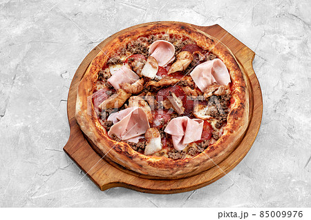 Meat Italian pizza with roast beef, steak slices, melted cheese, with olive slices and cheddar cheese. Close up, macro. Pizza time concept. Meat Italian pizza with roast beef, steak slices, melted cheese, with olive slices and cheddar cheese. Close up, macro. Pizza time concept. 85009976
