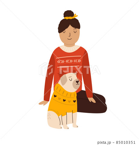 Young girl in a sweater sitting with her pug dog in holiday clothing Young girl in a sweater sitting with her pug dog in holiday clothing 85010351