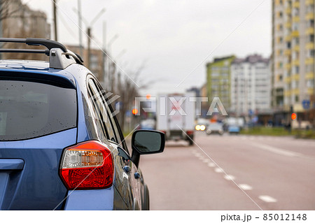 Closeup of rear headlight of new clean car parked on a city street side. 85012148