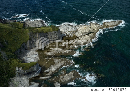 Aerial shot of Cape Stolbchaty on Kunashir Island at low tide on a sunny day. Volcanic formations of the seabed are clearly visible. It is a unique geological formation.is included in Unesco Aerial shot of Cape Stolbchaty on Kunashir Island at low tide on a sunny day. Volcanic formations of the seabed are clearly visible. It is a unique geological formation.is included in Unesco 85012875