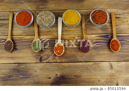 Set of different aromatic spices on wooden table. Top view 85013594