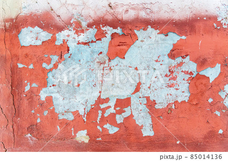 Old weathering cracks with peeling red paint smeared with cleaned wall texture. 85014136