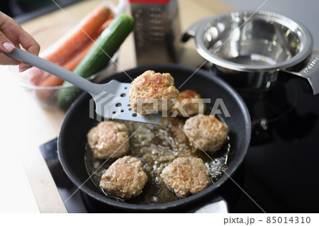 Tasty aromatic meat balls frying in oil on pan on kitchen stove Tasty aromatic meat balls frying in oil on pan on kitchen stove 85014310