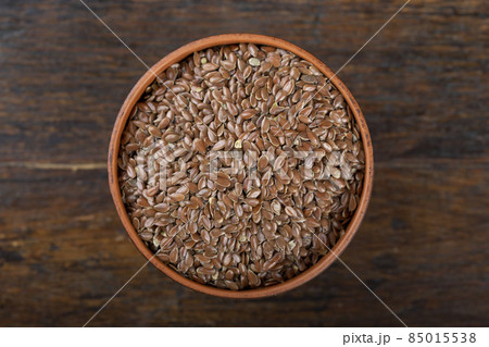 Clay bowl with flax seeds. Top view. Clay bowl with flax seeds. Top view. 85015538