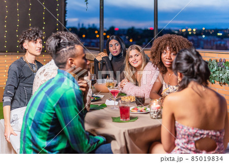 Friends celebrating New Year's Eve on balcony 85019834
