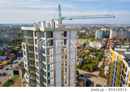 Aerial view of high residential apartment building with storey numbers on wall under construction. Real estate development. Aerial view of high residential apartment building with storey numbers on wall under construction. Real estate development. 85019913