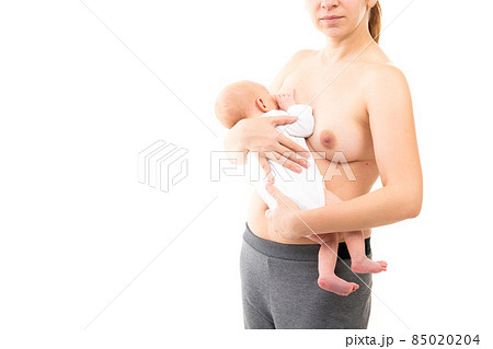 young mother on a white background breastfeeds her baby young mother on a white background breastfeeds her baby 85020204