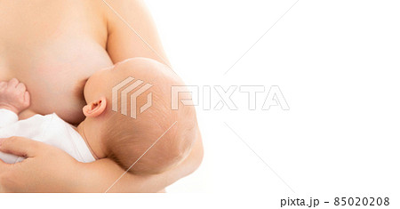 close-up of the female breast from which the child the infant drinks milk, natural feeding of the 85020208