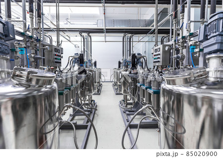 Photo of pipes and tanks. Chemistry and medicine production. Pharmaceutical factory. Interior of a Photo of pipes and tanks. Chemistry and medicine production. Pharmaceutical factory. Interior of a 85020900