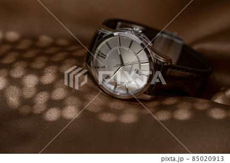 Mechanical wristwatch with manual winding on brown background Mechanical wristwatch with manual winding on brown background 85020913