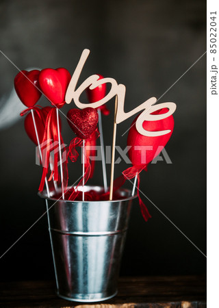 Valentine day love beautiful. Heart gaarland hanging on branch of tree on, photo zone with photo props and kissing booth 85022041