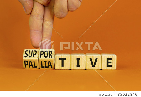 Palliative or supportive therapy symbol. Doctor turns cubes, changes words palliative to supportive. Beautiful orange background, copy space. Medical, palliative or supportive therapy concept. Palliative or supportive therapy symbol. Doctor turns cubes, changes words palliative to supportive. Beautiful orange background, copy space. Medical, palliative or supportive therapy concept. 85022846