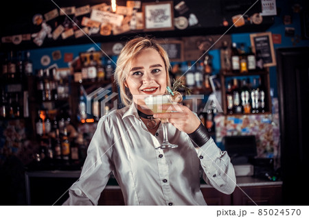 Girl bartender concocts a cocktail on the bar 85024570