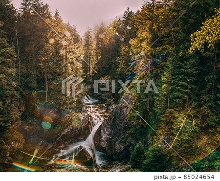 Tatra National Park, Poland. Waterfall Wodogrzmoty Mickiewicza In Summer Mountains Sunset Landscape. Sunlight Through Trees In Tatras. European Nature. UNESCO Tatra National Park, Poland. Waterfall Wodogrzmoty Mickiewicza In Summer Mountains Sunset Landscape. Sunlight Through Trees In Tatras. European Nature. UNESCO 85024654