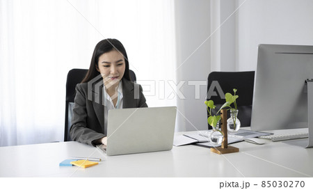 Attractive businesswoman working with modern devices in office. Attractive businesswoman working with modern devices in office. 85030270