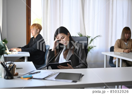 Young asian businesswoman suffering stress working at office. 85032026