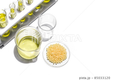 Nickle chloride liquid in test tube, Candelilla Wax in Chemical Watch Glass and alcohol in beaker place on white laboratory table. 85033120