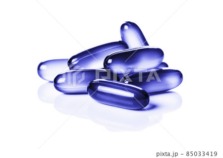 Close up of violet, purple soft gel capsules isolated on the white background Close up of violet, purple soft gel capsules isolated on the white background 85033419