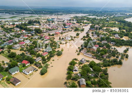 Aerial view of flooded houses with dirty water of Dnister river in Halych town, western Ukraine. Aerial view of flooded houses with dirty water of Dnister river in Halych town, western Ukraine. 85036301